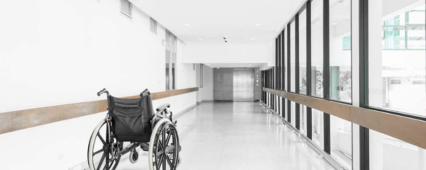 empty wheelchair in empty hospital hallway