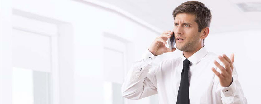 man in shirt and tie is on the phone