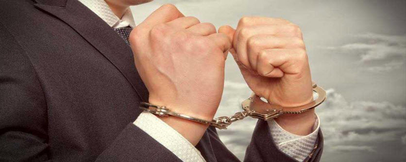 man in suit in handcuffs